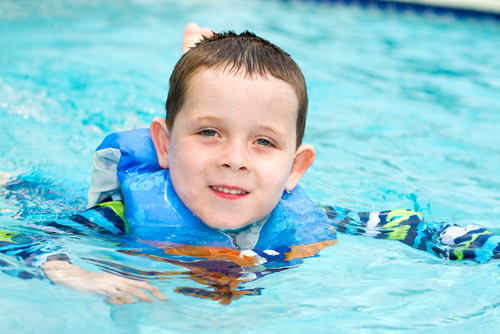 boy swimming in pool