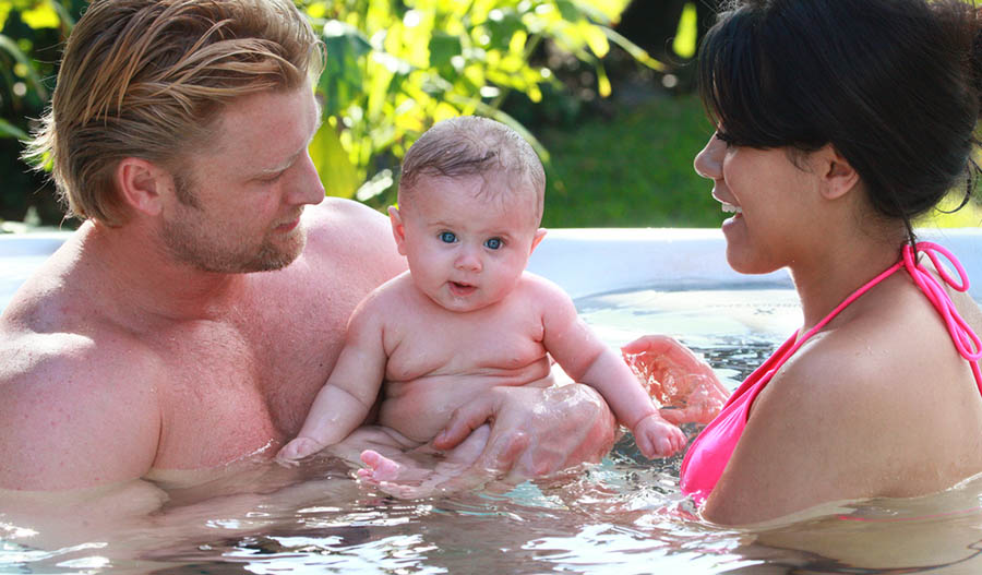 family enjoying hot tub