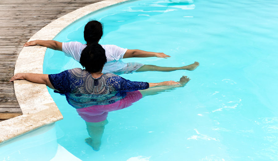 senior women exercising in pool