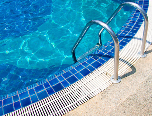side of pool with blue tiles